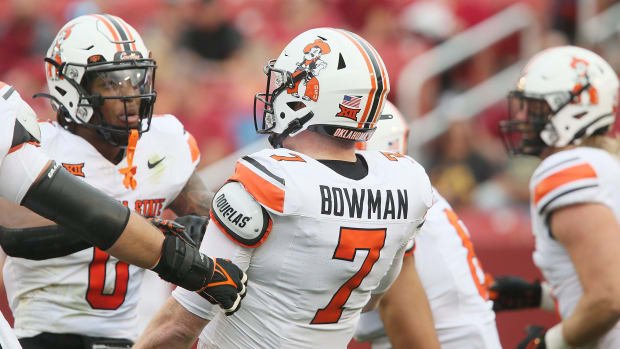 Oklahoma State Cowboys' quarterback Alan Bowman (7) celebrates with teammates after scoring from a touchdown during the first quarter of an NCAA college football game at Jack Trice Stadium on Saturday, Sept. 23, 2023, in Ames, Iowa.